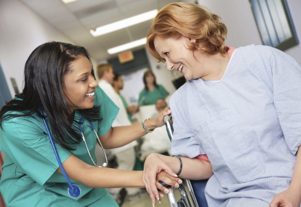 Female nurse talking to female patient