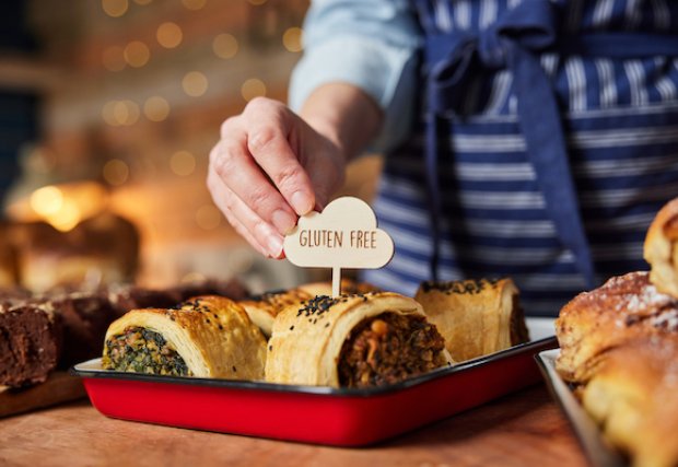 A chef holding a tray of gluten-free food