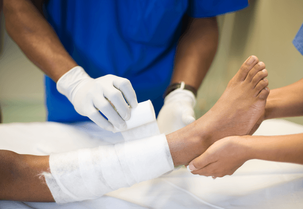 Doctor bandaging patients leg